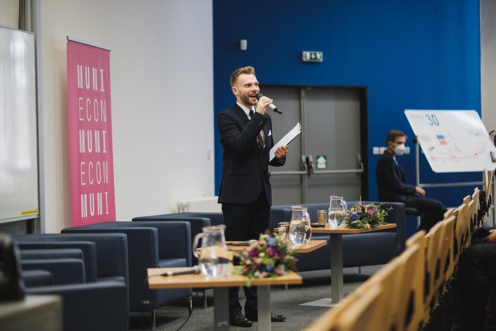 Aleš Kohout moderuje živou akci s mikrofonem v ruce